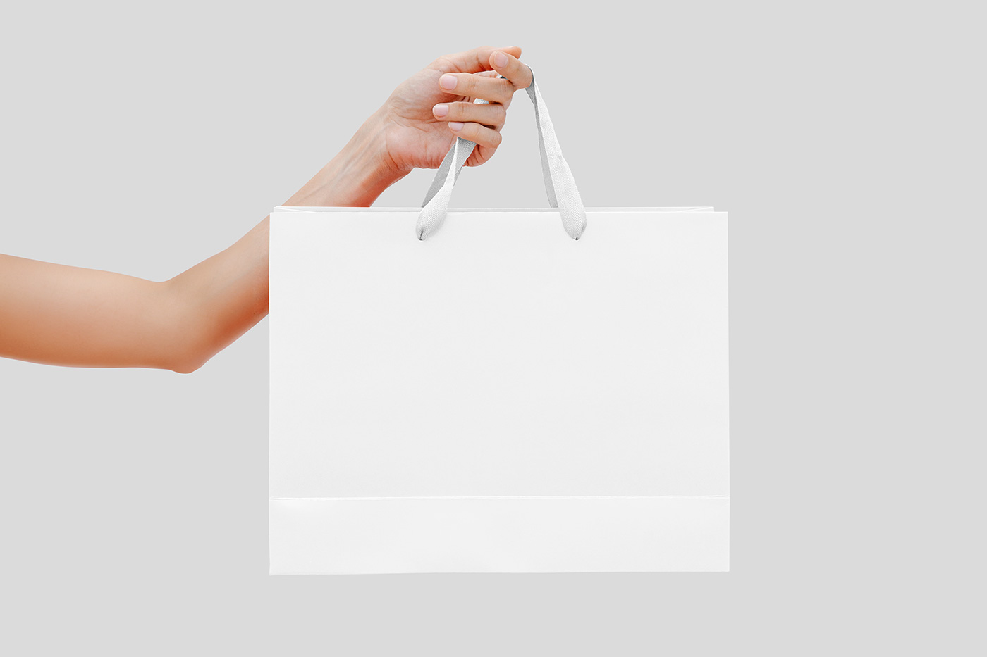 Free Shopping Bag in Hand Mockup - mockupbee