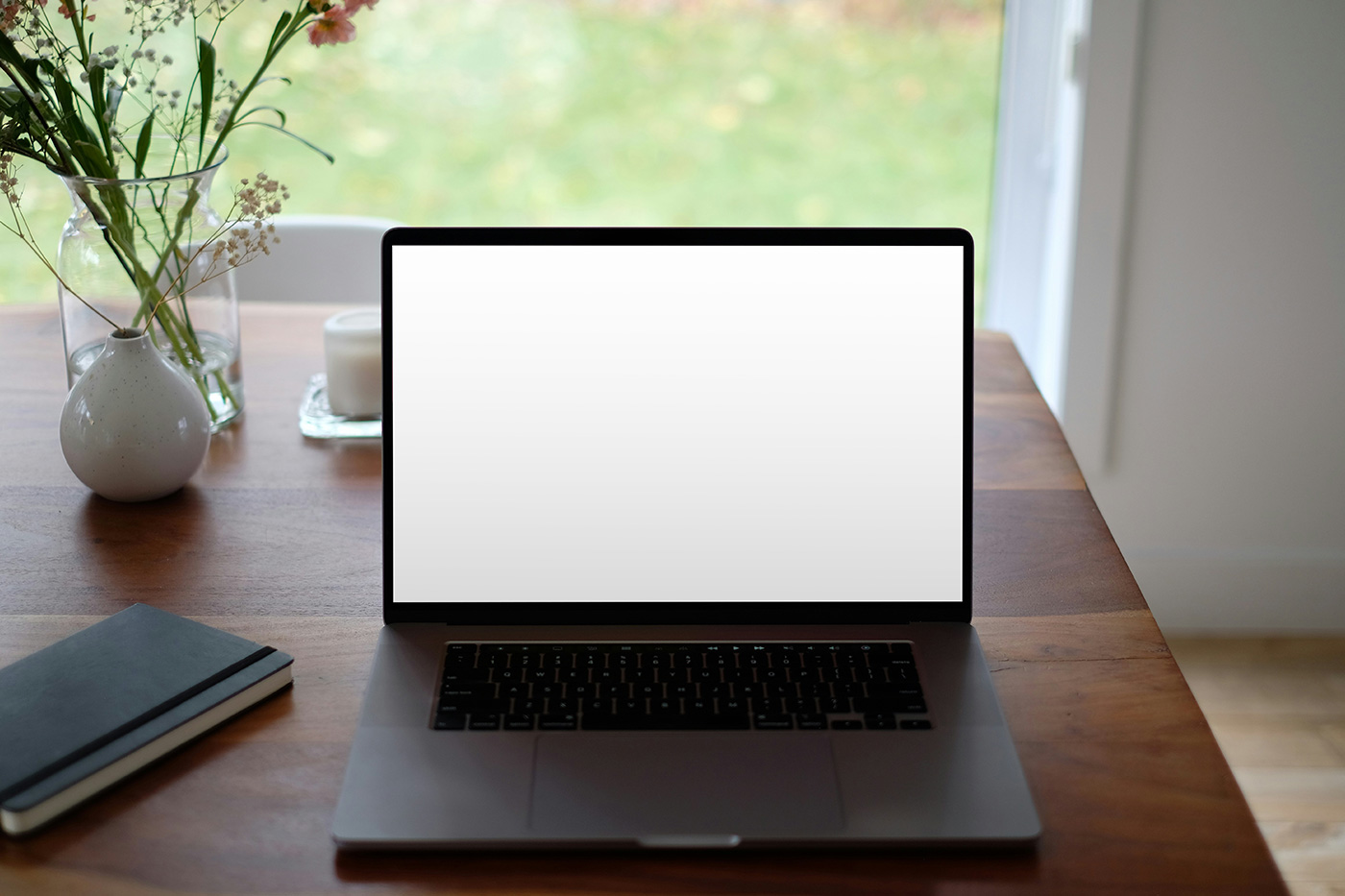 Free MacBook on Table Mockup - mockupbee