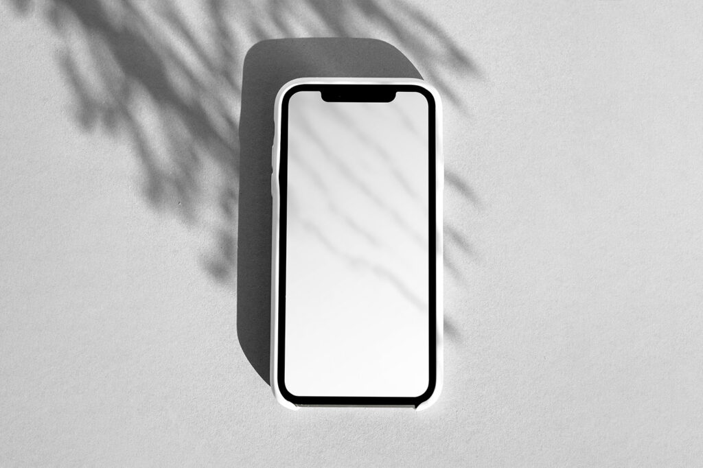 Free iPhone Screen in Shadow Mockup - mockupbee