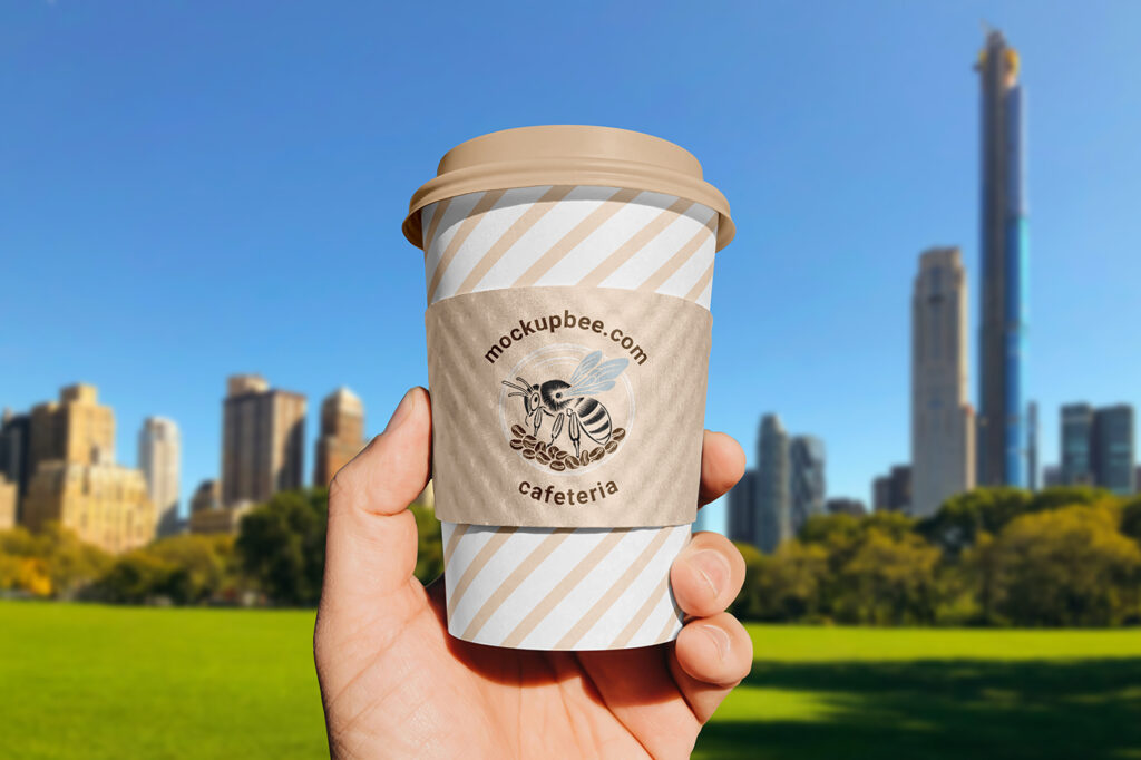Free Paper Cup Sleeve in Hand Mockup